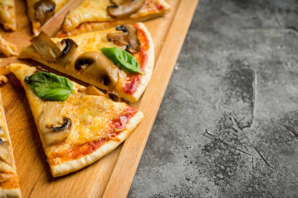 istock Freshly making pizza with mushrooms served on the rustic background 1217721769