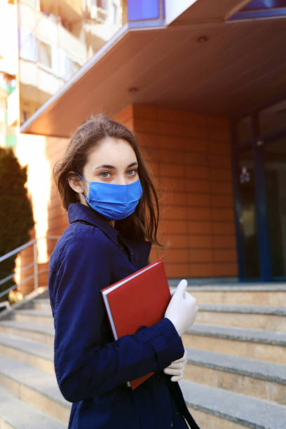 istock Young woman wearing face-protective mask and gloves 1217726630