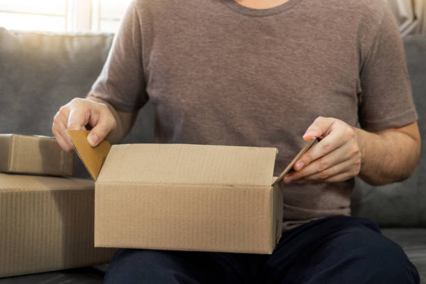 istock Startup small business entrepreneur SME, young asian man working with laptop computer and delivery packaging box, online market packing, SME e-commerce seller concept