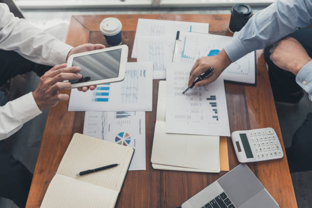 istock working together in office concept, young businessmen using touchpad digital tablet to discuss the situation on the market or stock yield graph chart at meeting office 1217726824