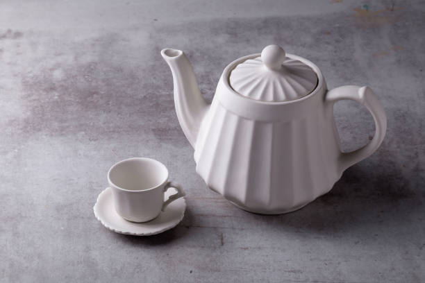 istock Teapot creamer, Cup and saucer on Cement Board 1217727670