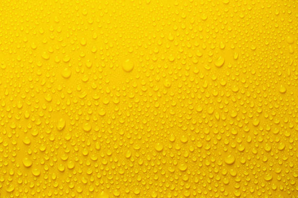 istock Rain or Water drops on yellow background 1217727787