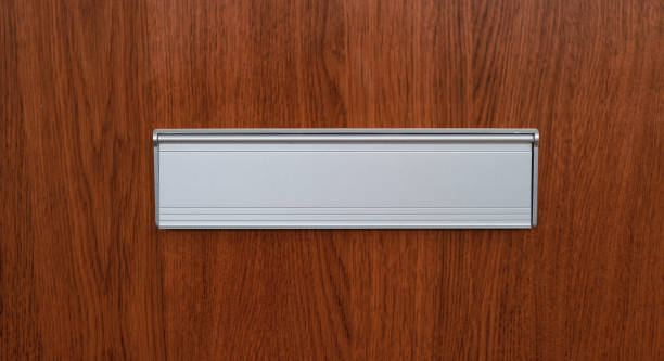 istock A mail slot on a wooden door 1217729338