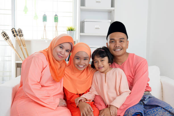 Hari raya Aidilfitri Happy Malay family portrait in traditional clothing during Hari Raya. Malaysian family lifestyle at home. malay stock pictures, royalty-free photos & images