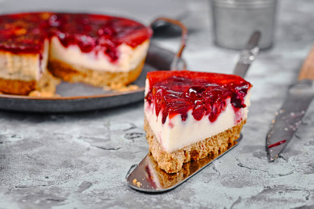istock Single piece of cheesecake with cherry glaze topping on cake server 1217730435