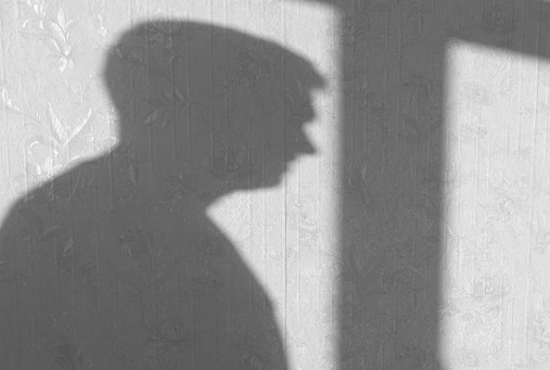 Shadow or silhouette of man on wall in room, abstract background shadows of people