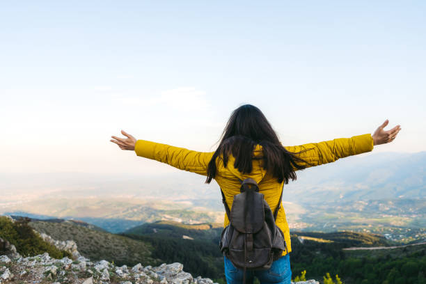 istock Woman standing high up on mountain 1217731371