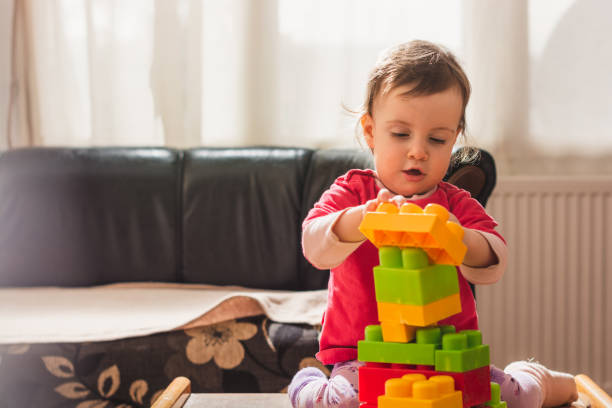 istock Small girl playing with plastic blocks 1217731569