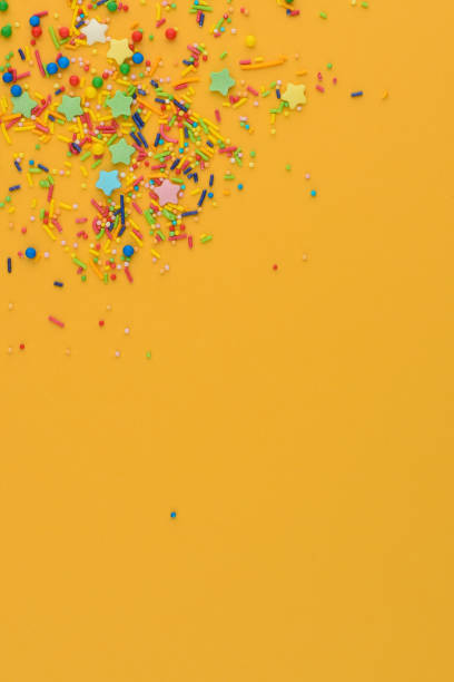 istock Decorative sprinkles border on yellow. Copy space. 1217731837