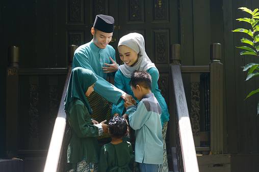 Muslim family greeting, Hari Raya Eid Al-Fitr concept.