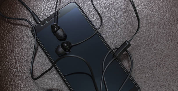 istock Smartphone and earphones placed on leather floor 1217733016
