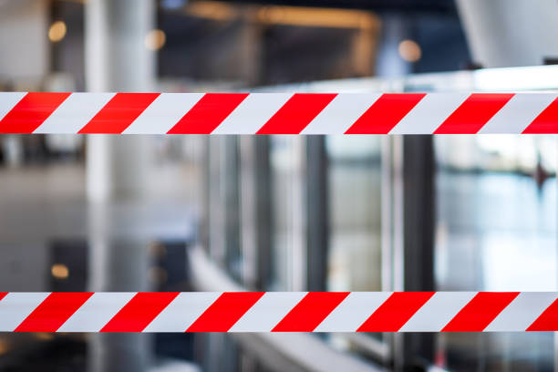 istock Red and white warning tape stretched across danger area 1217733904