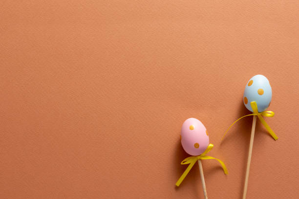 istock Decorative ornaments in the form of Easter eggs on an orange background. Copy space. Easter holiday concept. 1217735453