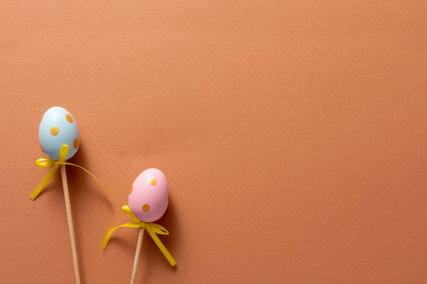 istock Decorative ornaments in the form of Easter eggs on an orange background. Copy space. Easter holiday concept. 1217735468