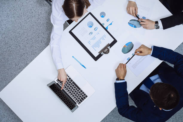 istock Group of business people analyzing financial documents, view from above. Business team at meeting 1217739027