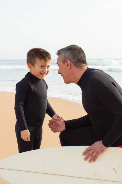 istock Smiling father talking with little son 1217740184