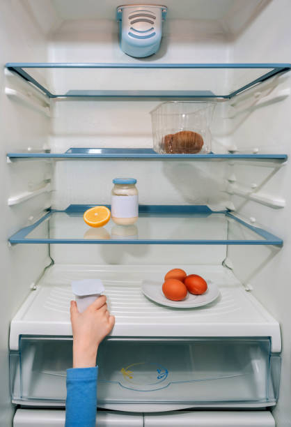 istock Girl hand taking the last yogurt from the fridge 1217740427