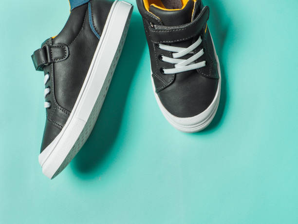 istock Gray and yellow sneakers on blue background 1217740518