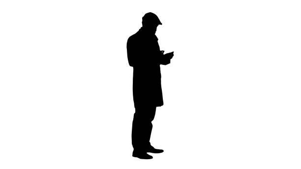 istock Silhouette Man dressed in trenchcoat in protection mask using sa 1217740831