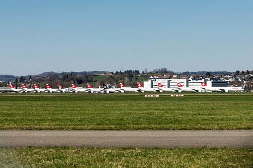 Dübendorf, Switzerland - April 8, 2020: A long line-up of grounded airplanes in Switzerland. The coronavirus crisis has become an existential threat to the airline industry.