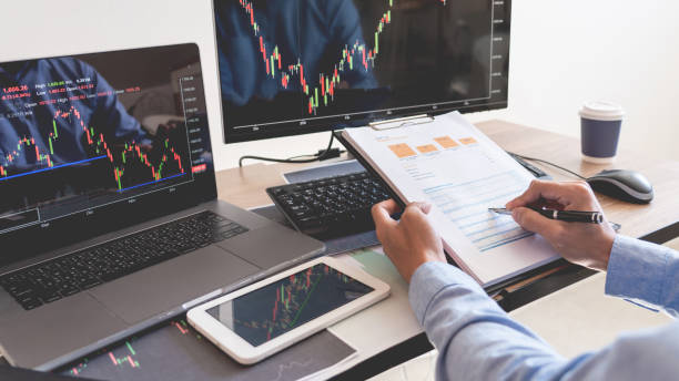 istock Businessman broker Analyzing finance data graphs and reports on screen for investment purposes for trading graph of stock market 1217742994