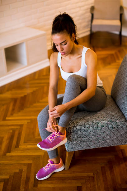 istock Young attractive woman preparing for exercises at home 1217745530