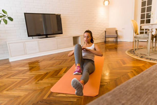 istock Young attractive woman practicing exercises on the floor at home 1217745558