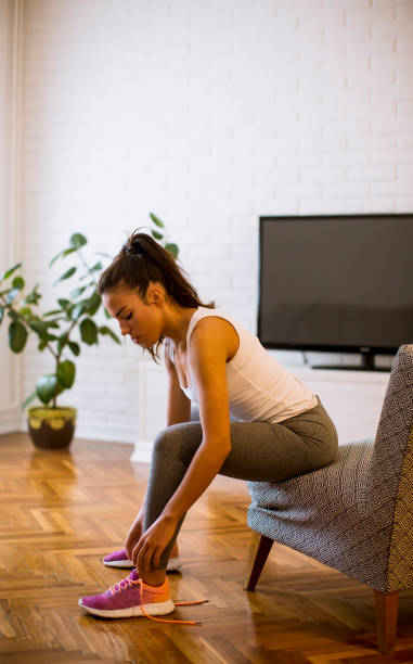 istock Young attractive woman preparing for exercises at home 1217745629