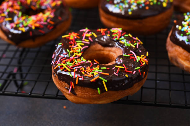 istock American donut with chocolate and candy on a concrete background. 1217747535