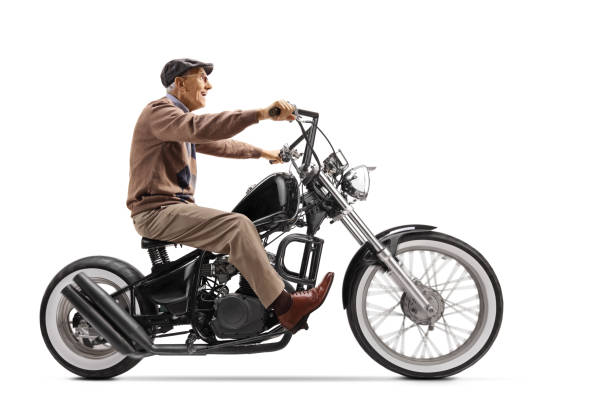 istock Elderly man riding a custom chopper motorbike 1217747603