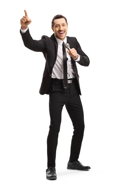 Man in a suit holding a microphone and gesturing with finger