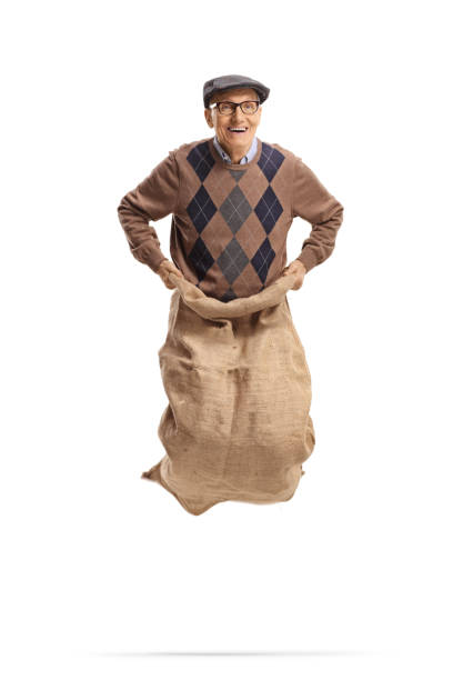 happy elderly man jumping inside a sack - gunny sack imagens e fotografias de stock