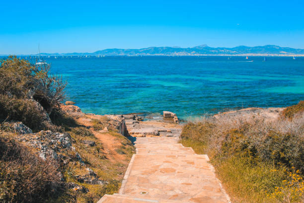 View over beautiful coast with sailing boats in the south of Mallorca, Spain