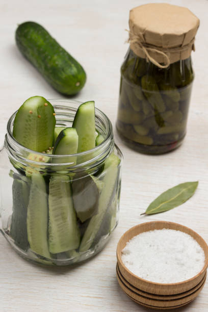 istock Chopped cucumbers in glass jar, salt. Canned cucumbers, 1217754316