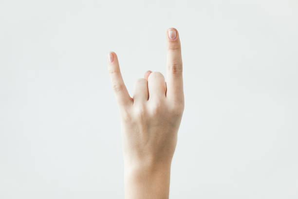 istock Devil horns gesture with fingers on the light background 1217755004