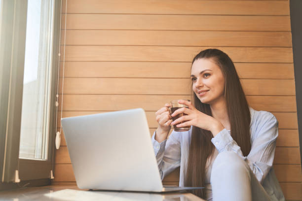 istock Dreamy female telecommuter enjoying her tea break 1217759334
