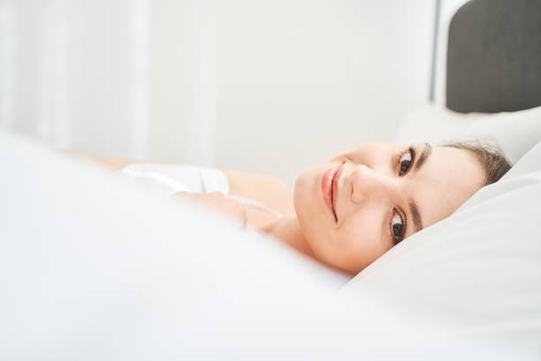 istock Girl in bed posing for the camera 1217759433