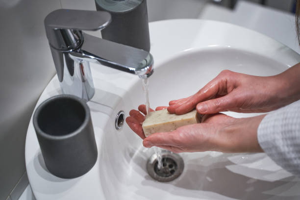 istock Girl using a soap bar for hand hygiene 1217759561