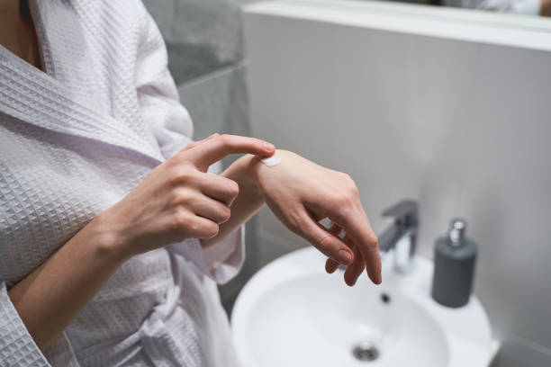 istock Young woman hydrating her hands with a moisturizer 1217759585
