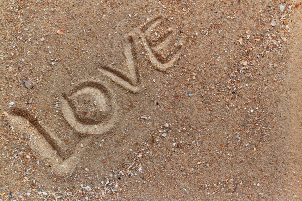 istock inscription love in the sand, close-up 1217760179