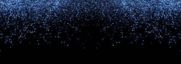 istock Abstract blue defocused glitter holiday panorama background on black. Falling shiny sparkles. New year Christmas glowing backdrop 1217760501