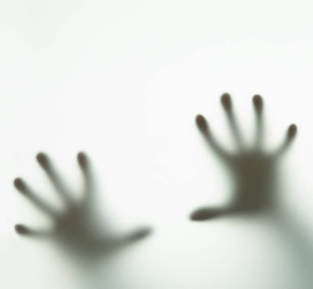 istock blurry human arms behind glass 1217761093