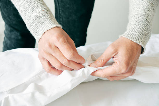 istock caucasian man making the bed 1217762104