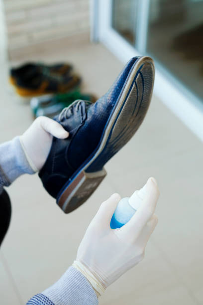 istock man disinfecting his shoes 1217762260