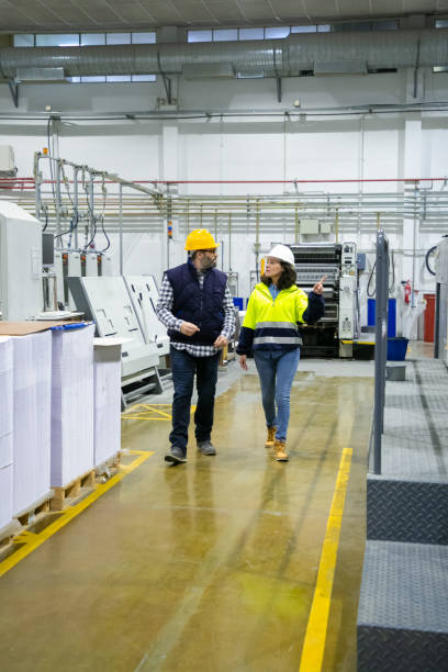 istock Full length of foreman and inspector discussing equipment 1217762467