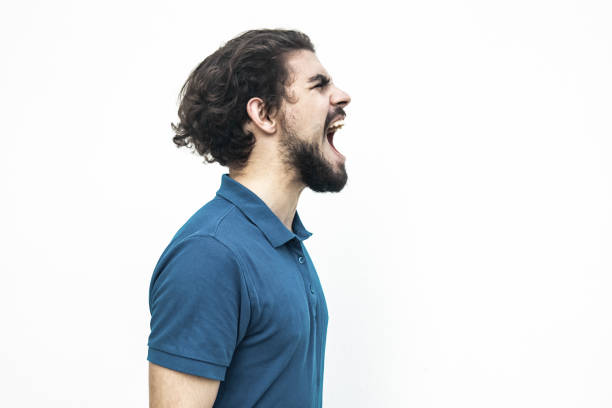 istock Side of excited guy shouting loud at copy space 1217763454