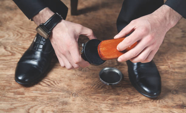 istock Man polishing shoes with a brush. 1217763745