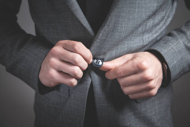 istock Man fastening buttons on suit. 1217763760