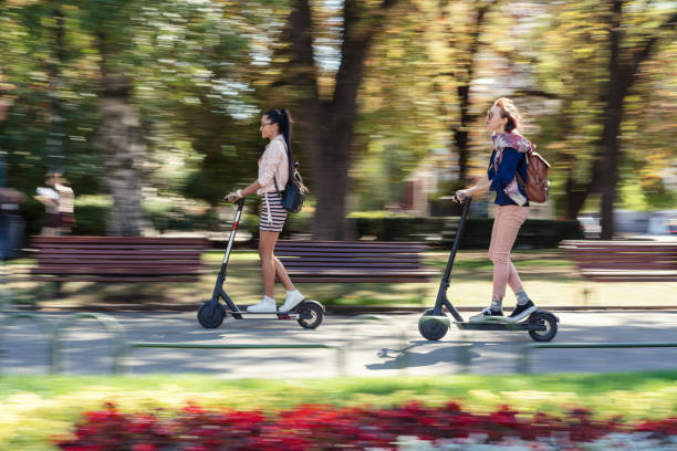 istock Girlfriends commuting the city on electric scooters 1217765424