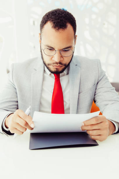 istock Serious businessman working with contract 1217765895
